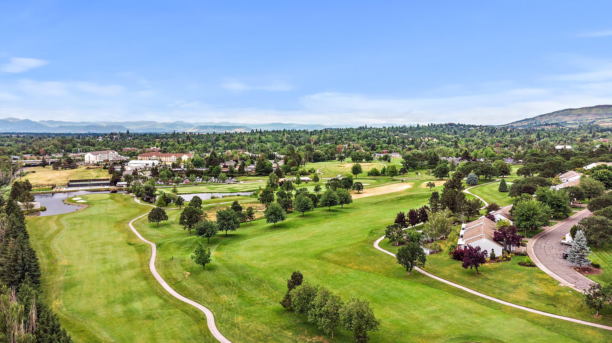 Aerial view of the Rogue Valley Manor area, showing lots of trees and a walking path.