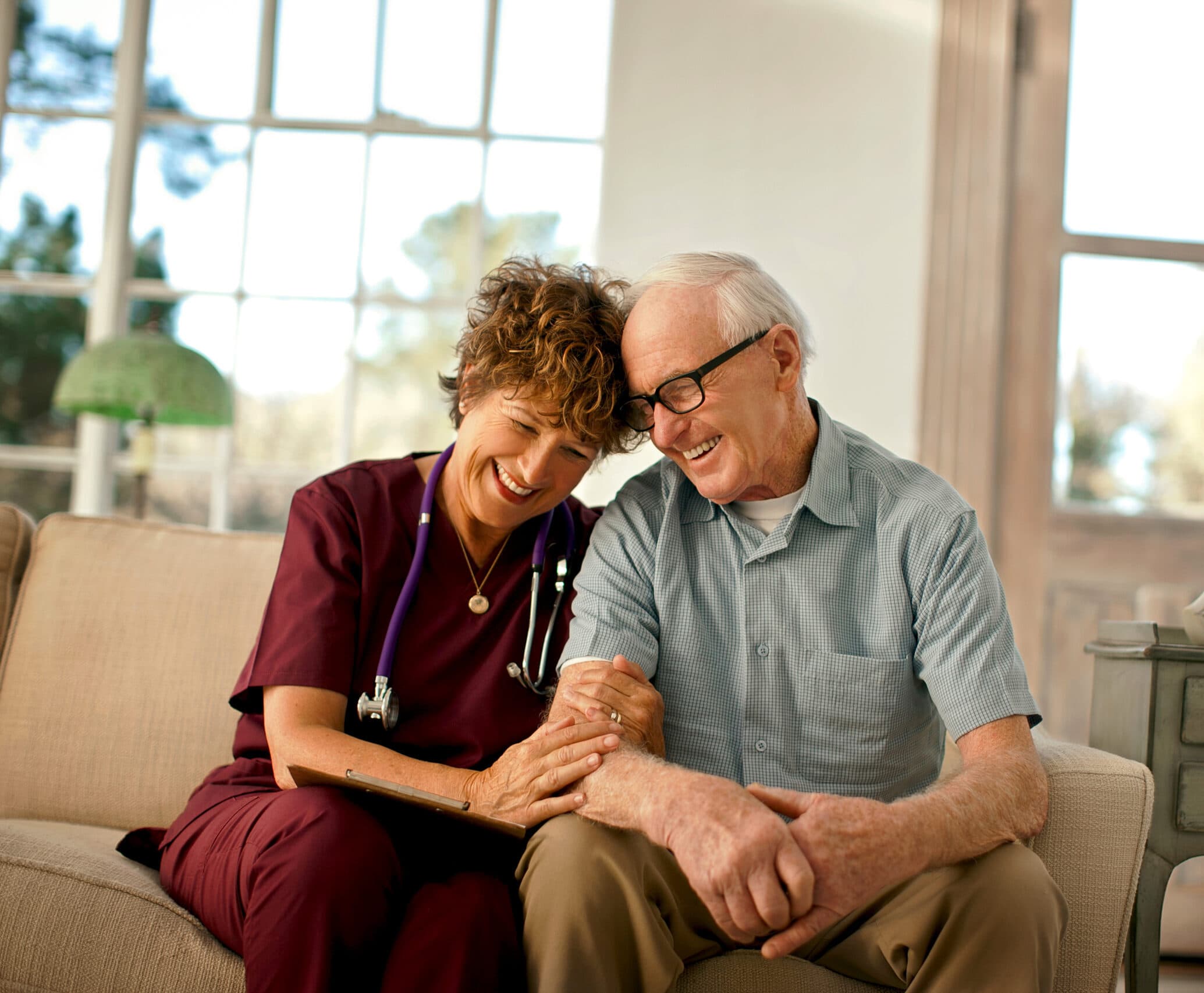 A compassionate home care nurse comforts a patient.